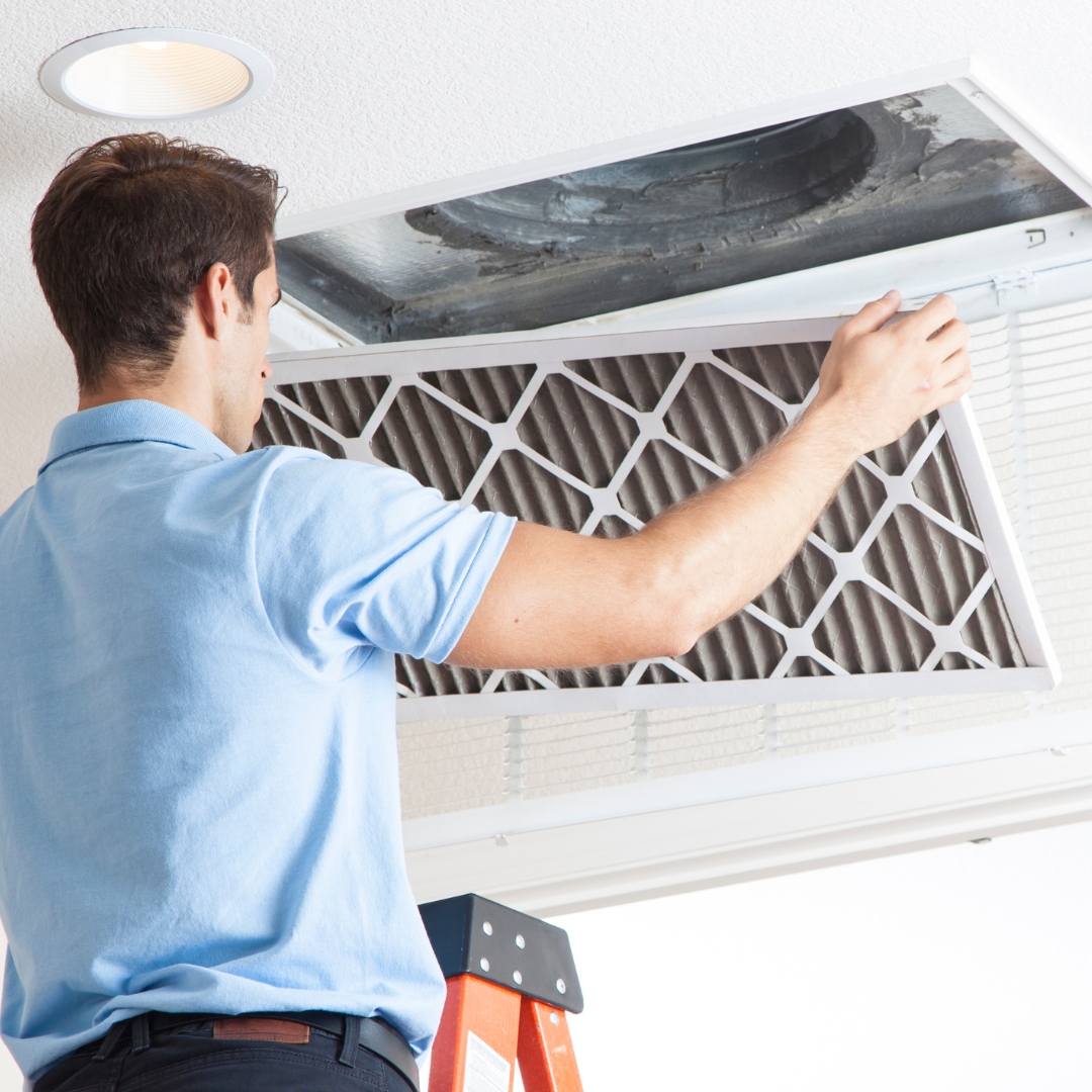 An HVAC expert changing a home ventilation filter