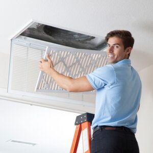 a professional replacing an air filter in a home to improve air quality