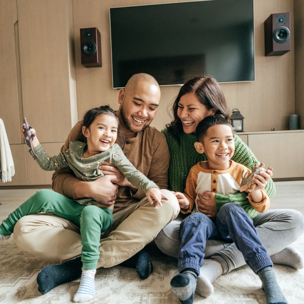 a family happily playing together in their home