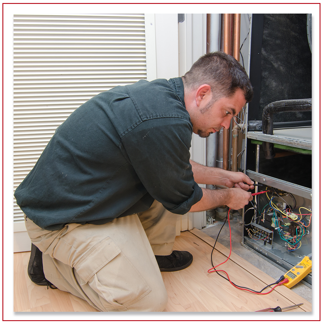 hvac technician repairing home furnace