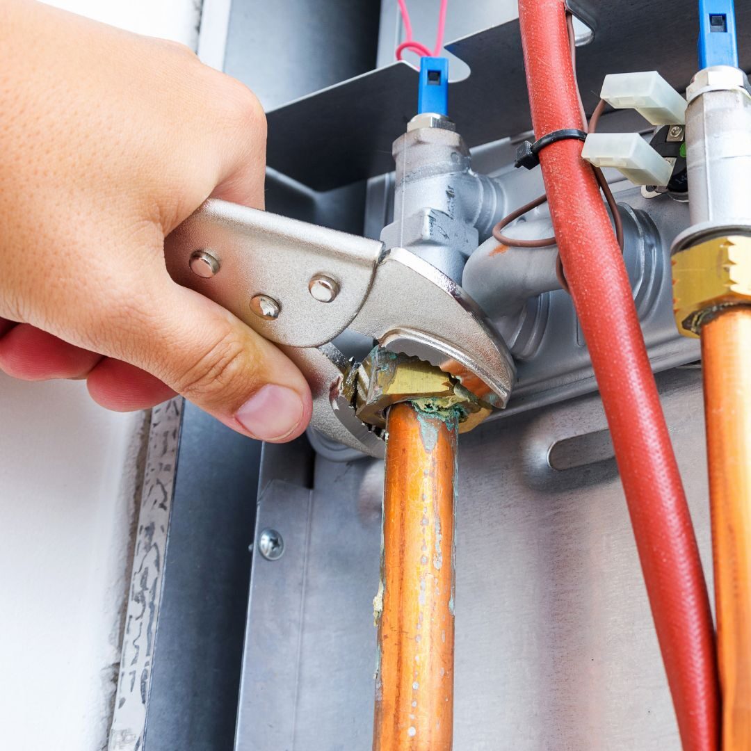 An HVAC expert working on a furnace