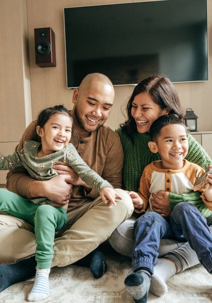 a family happily playing together in their home